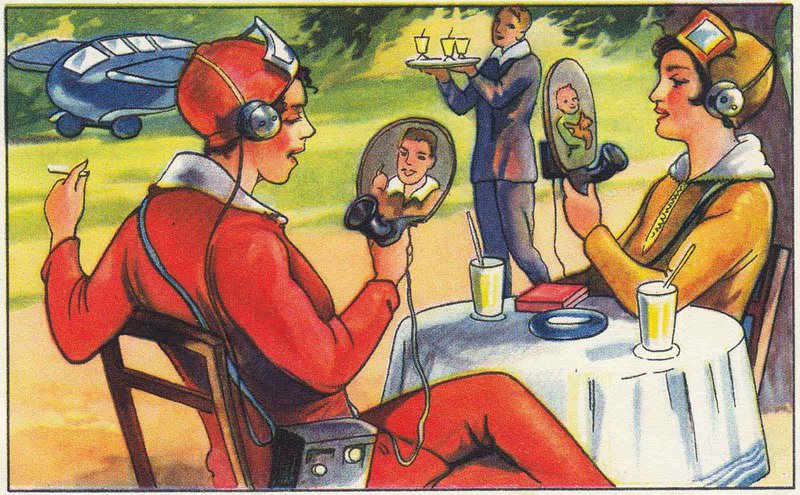 German margarine card 1930 showing 2 women talking on round-screened "video phones", with headphones, while a water carries a tray of drinks in the near background.. A flying car is parkesd further away.